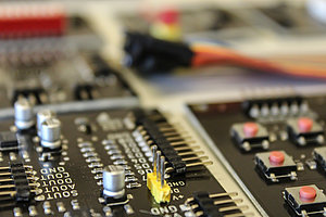 A close-up shot of an electronic circuit board featuring various components such as integrated circuits.